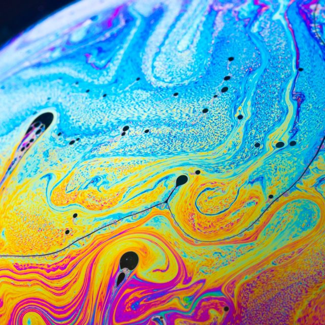 Rainbow soap bubble on a dark background