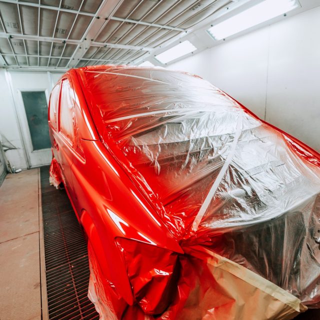 Red van being paint in special paint booth, Car painting details